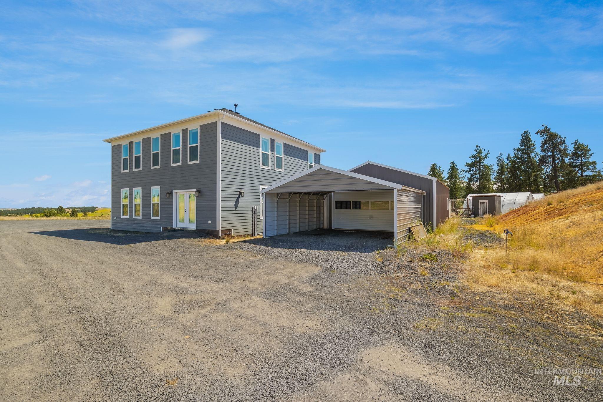4935 Lenville Road Moscow, ID 83843 - Photo 5 of 49 Two-story residence featuring gray siding and white-framed windows