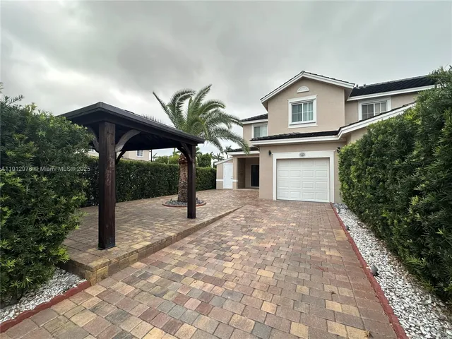 a view of a house with a yard and plants