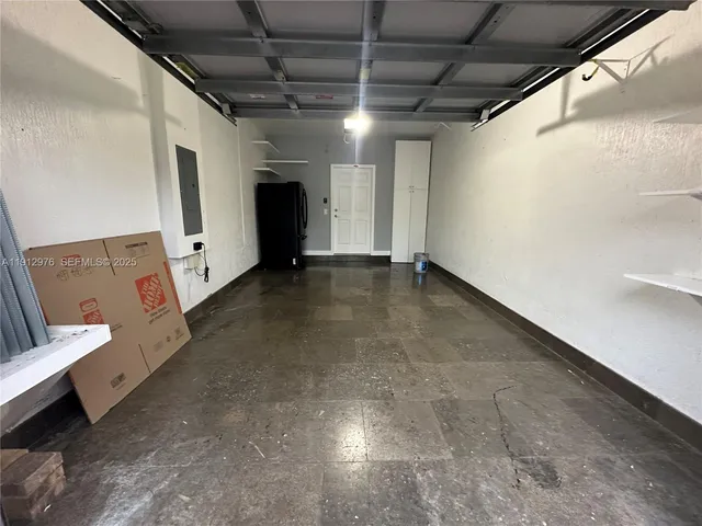 a view of room with refrigerator and window