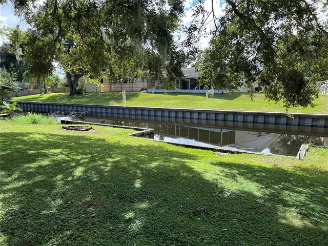 a view of a swimming pool with a yard and green space