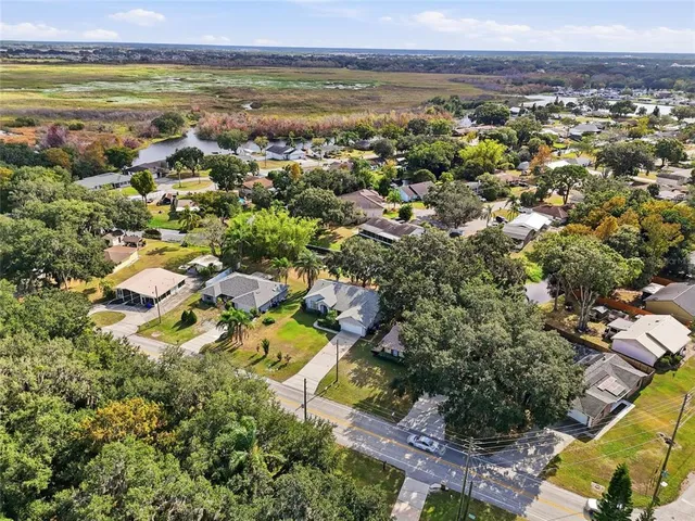 an aerial view of residential houses with outdoor space and swimming pool