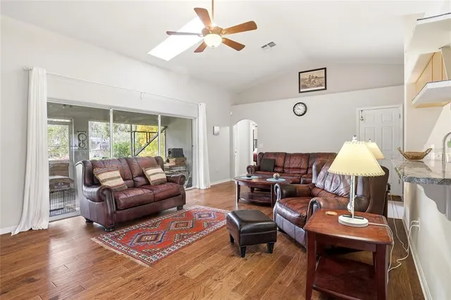a living room with furniture a lamp and a window