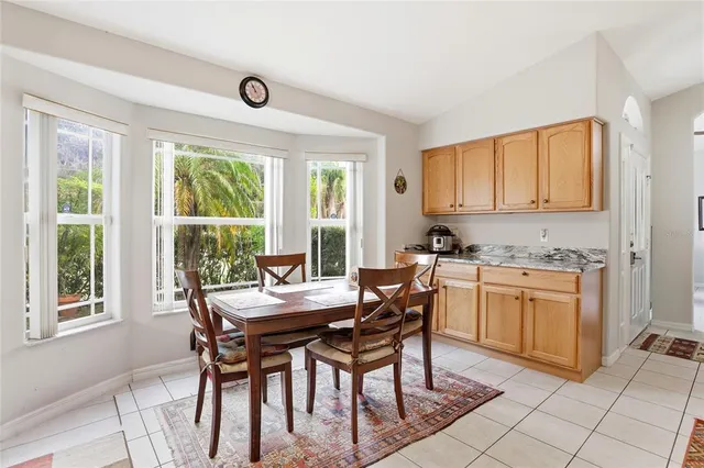 a view of a dining room with furniture and a window