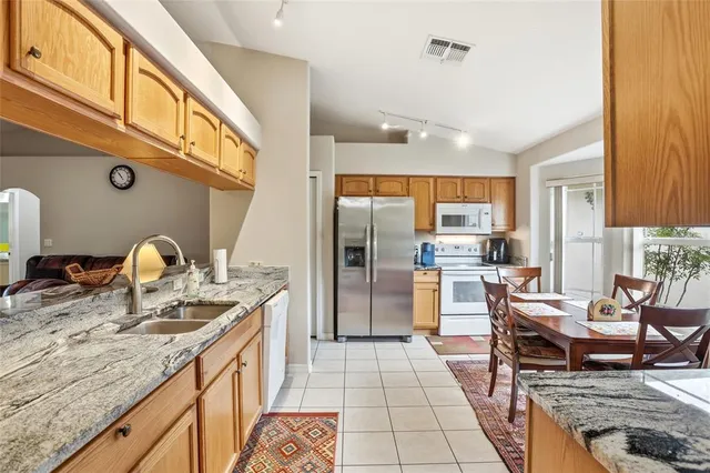 a kitchen with stainless steel appliances granite countertop a sink and cabinets