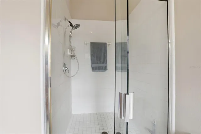 a bathroom with a glass shower door