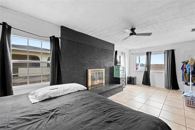 a bedroom with a large bed and a large mirror