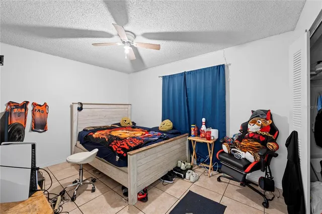 a bedroom with furniture and musical instruments