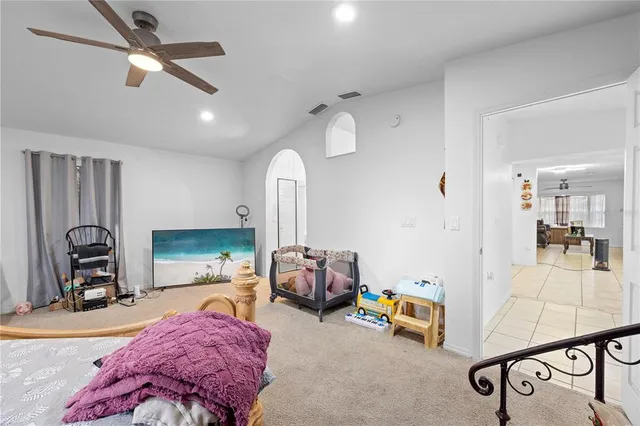 a bedroom with furniture and a flat tv screen