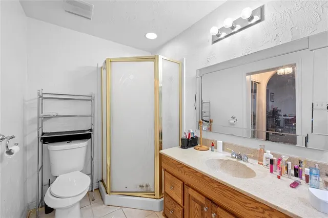 a bathroom with a granite countertop sink a toilet and a mirror
