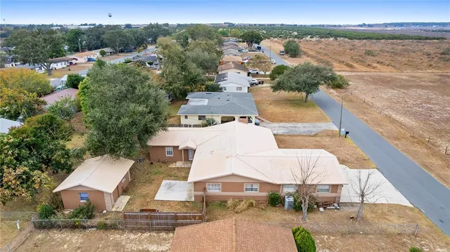 an aerial view of a house with a lake view