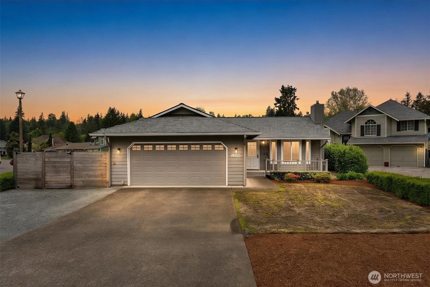 21910 Southeast 239th Street Maple Valley, WA 98038 - Photo 1 of 38 a front view of a house with a yard and garage