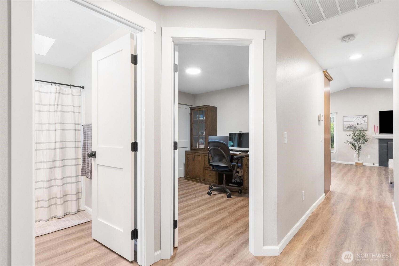 21910 Southeast 239th Street Maple Valley, WA 98038 - Photo 18 of 38 a view of a hallway with living room and wooden floor