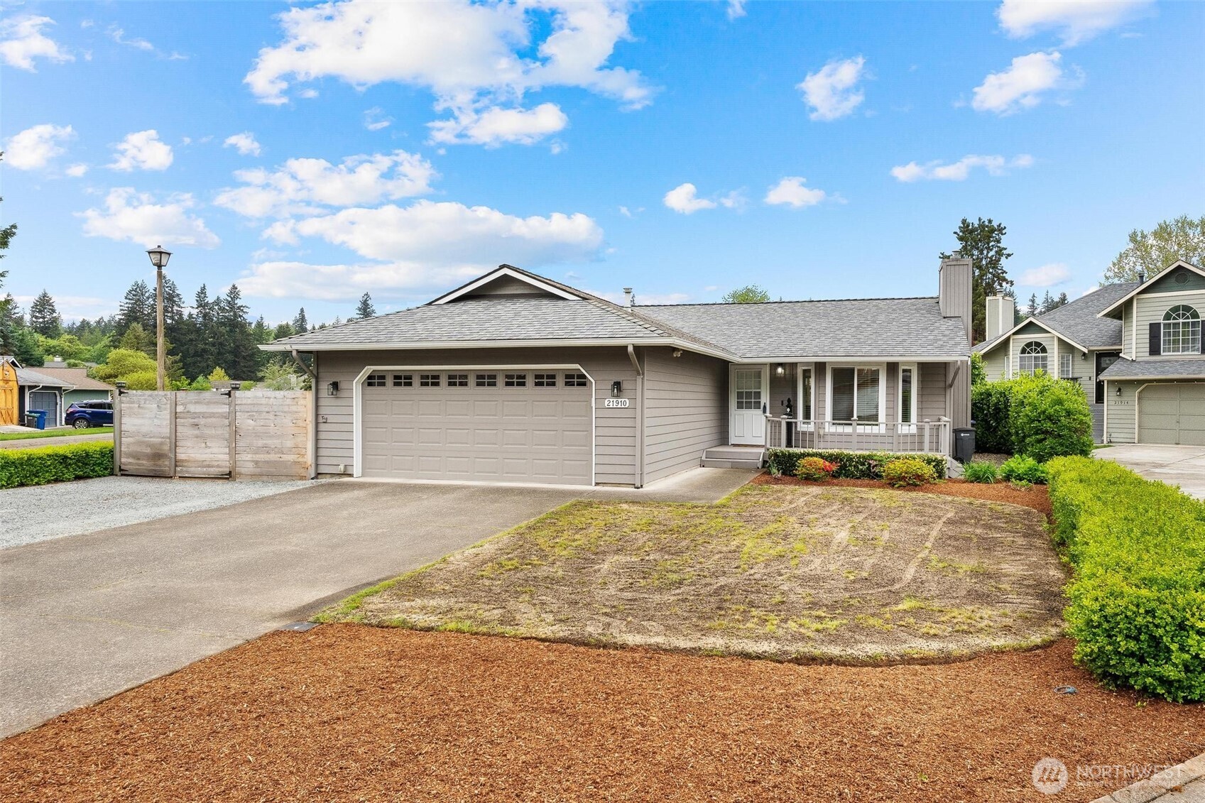 21910 Southeast 239th Street Maple Valley, WA 98038 - Photo 24 of 38 a front view of a house with a garden