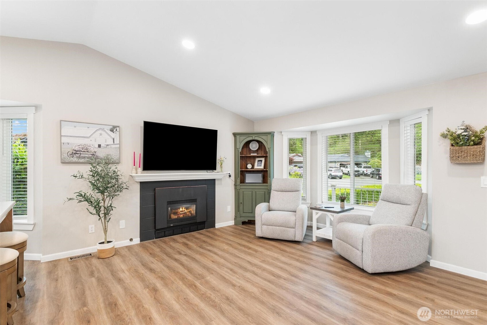 21910 Southeast 239th Street Maple Valley, WA 98038 - Photo 4 of 38 a living room with furniture a flat screen tv and a fireplace