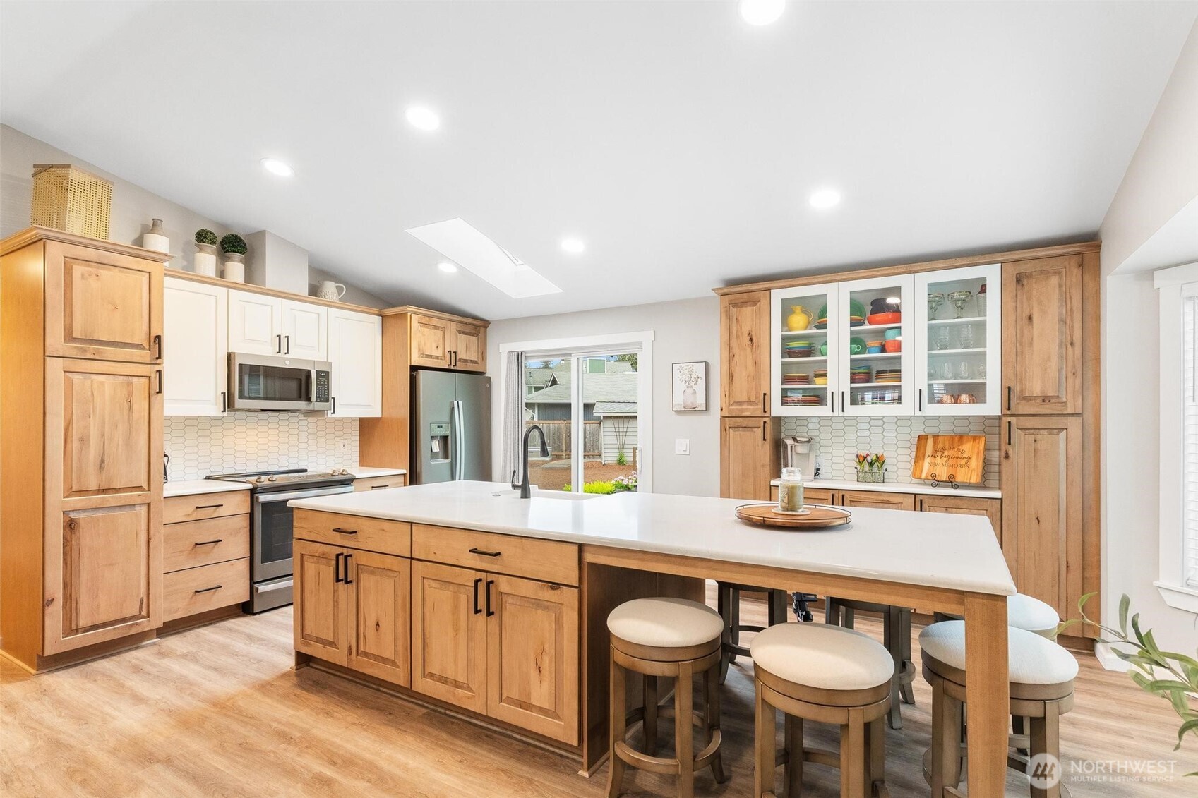 21910 Southeast 239th Street Maple Valley, WA 98038 - Photo 10 of 38 a open kitchen with stainless steel appliances granite countertop a stove and a sink