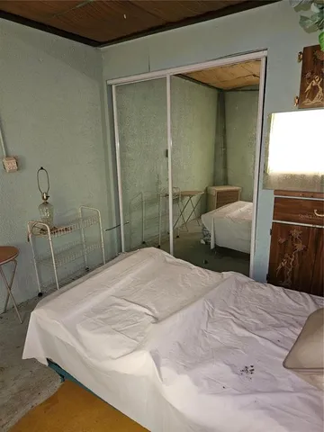 a bedroom with a bed and a chair