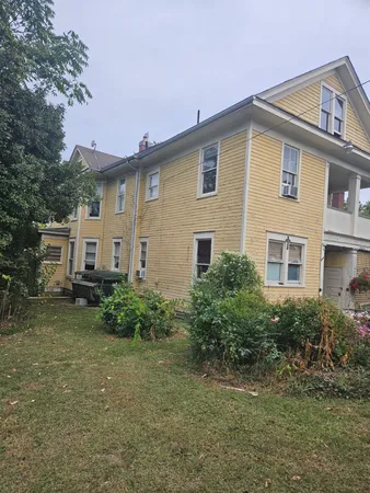 a view of a house with a yard