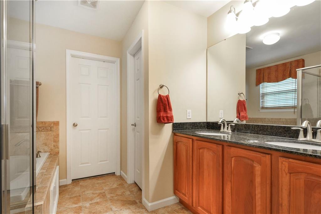 132 Walnut Drive McKees Rocks, PA 15136 - Photo 14 of 25 The master bath is equipped with a dual sink station and granite counter. The door straight ahead is the second walk-in closet. This closet measures 13'x6'! The door facing left is the water closet.