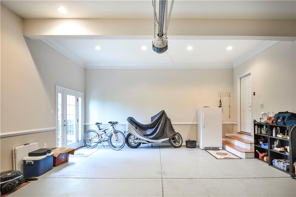 132 Walnut Drive McKees Rocks, PA 15136 - Photo 22 of 25 Even the garage is super! High 11' ceilings adorned with crown molding! Intercom! Man door to the left side yard. Clean as a whistle! The garage door measures approximately w - 15' 1/2" x h - 7'.