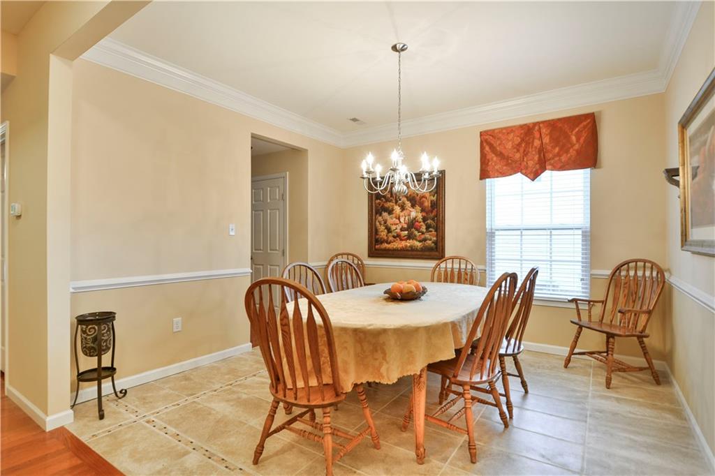 132 Walnut Drive McKees Rocks, PA 15136 - Photo 4 of 25 Down the hall from the den is the formal dining room. The tile flooring with inlay was more recently installed. Crown molding and chair rail lend an elegant touch. The hall and the door in the background are the full pantry and rear entry to the kitchen.