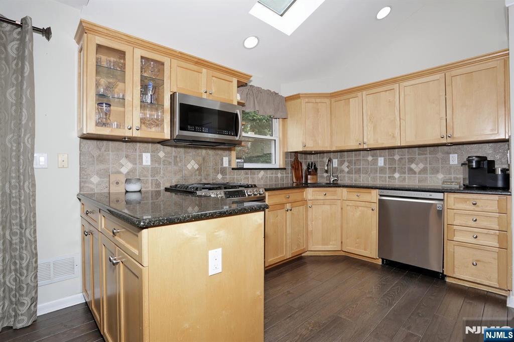 30 Brookfield Road Dumont, NJ 07628 - Photo 11 of 50 a kitchen with stainless steel appliances granite countertop a stove a sink and a microwave