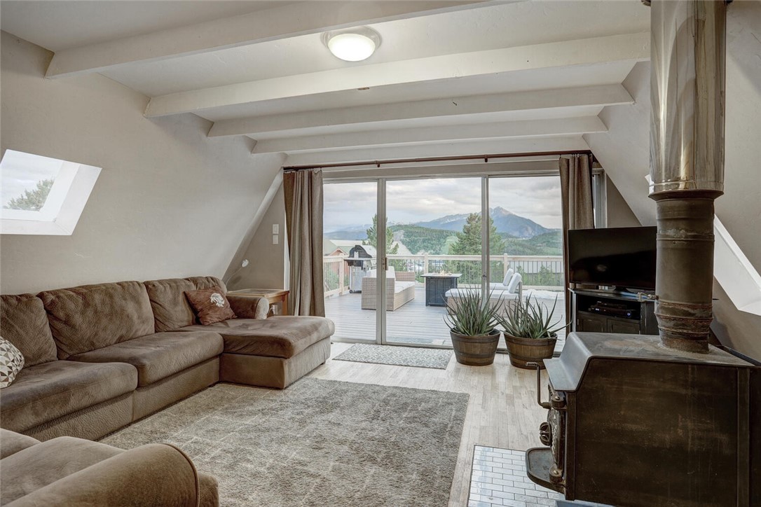 Cozy up next to the wood burning stove with views of Peak 1 from your living room