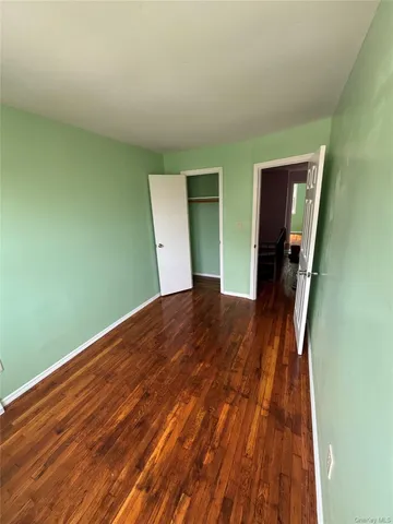 a view of a room with wooden floor and staircase