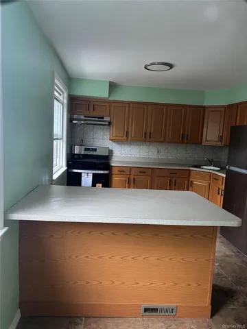 a view of kitchen cabinets and wooden floor
