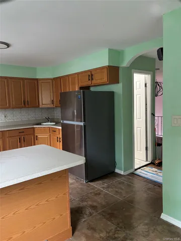 a kitchen with stainless steel appliances a refrigerator and a counter top space