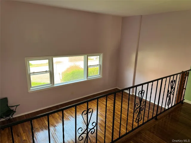 a view of staircase with three windows