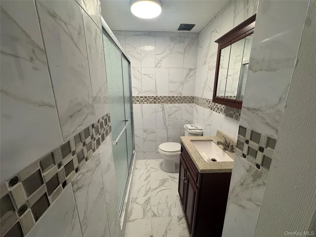 a bathroom with a sink a toilet and mirror