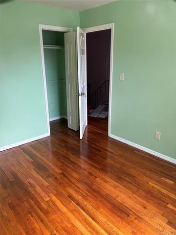 a view of a room with wooden floor and closet