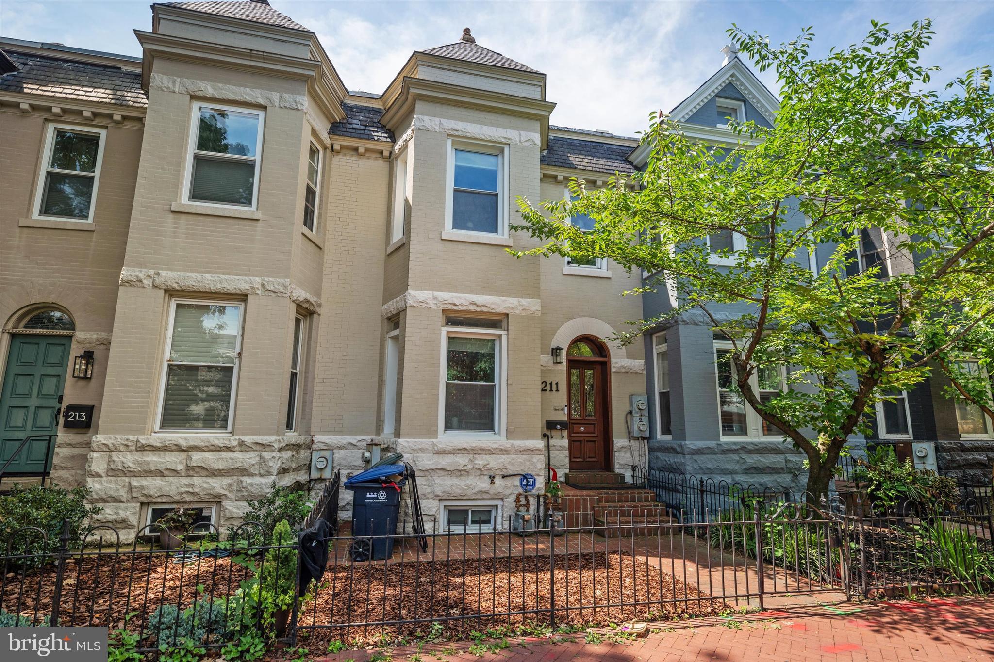 a front view of house with a garden