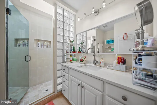 a bathroom with a sink double vanity and shower
