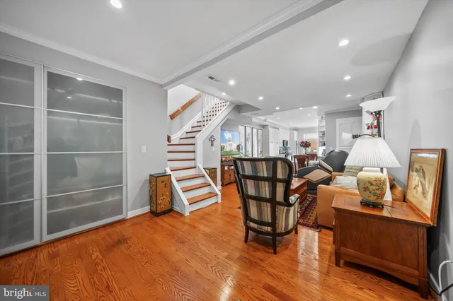 a dining room with furniture and wooden floor