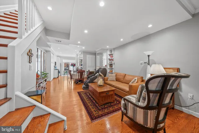 a living room with furniture a rug and a chandelier