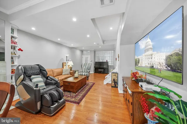 a living room with furniture fireplace and a large window