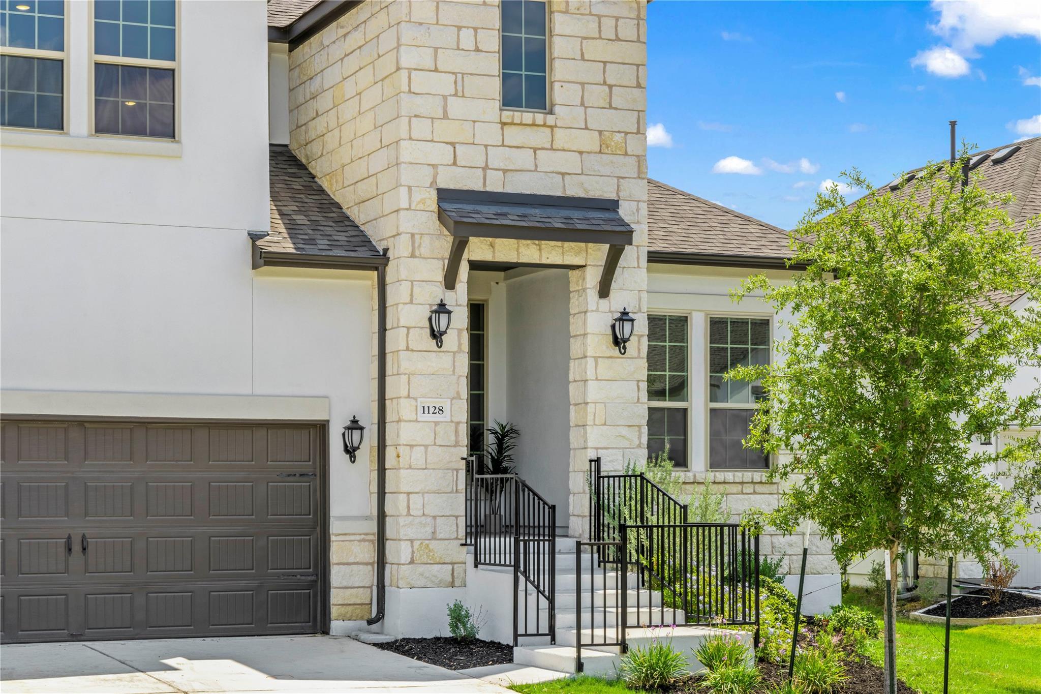 1128 Villa Rialto View Leander, TX 78641 - Photo 2 of 40 A striking contemporary facade with light stone and stucco offers inviting curb appeal.