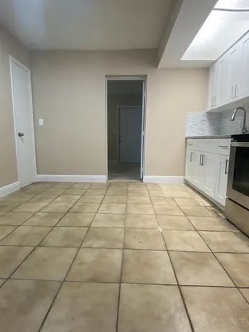a view of a kitchen with a sink and a stove top oven
