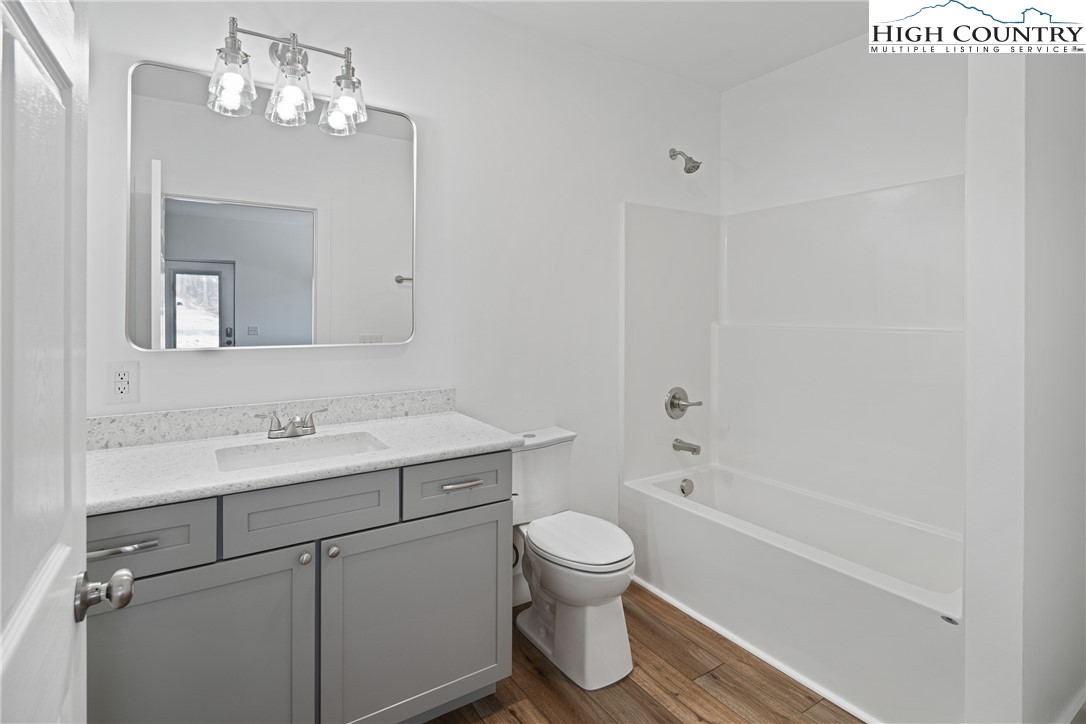 114 Woodpecker Road Purlear, NC 28665 - Photo 23 of 47 a bathroom with a sink a toilet and shower