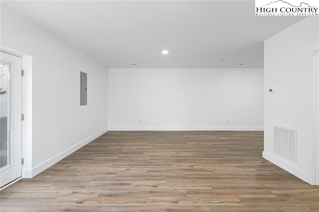 114 Woodpecker Road Purlear, NC 28665 - Photo 25 of 47 a view of an empty room with wooden floor