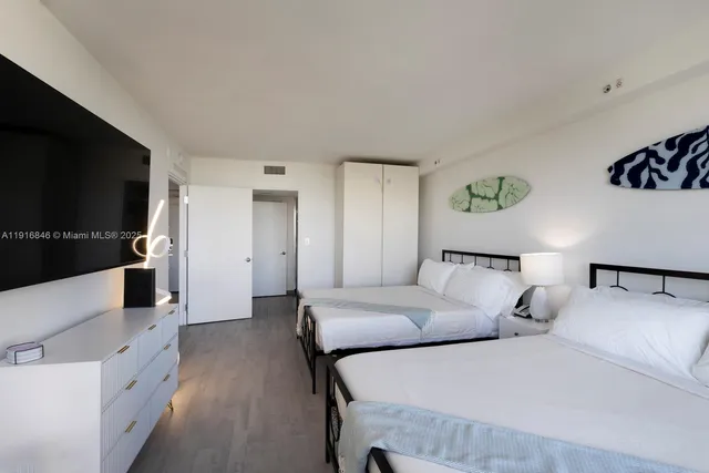 a hotel room with large bed and a flat screen tv