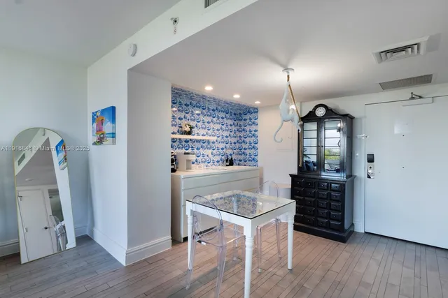 a view of a workspace with furniture and wooden floor