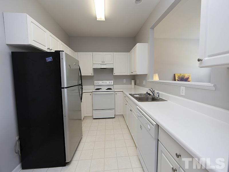 4100 Standing Rock Way Raleigh, NC 27604 - Photo 3 of 11 a kitchen with a refrigerator a stove a sink and cabinets
