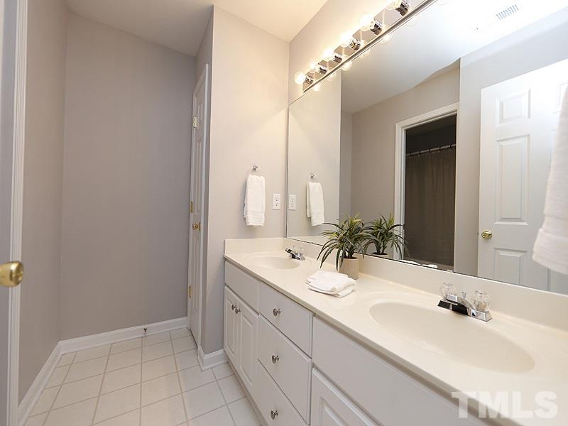 4100 Standing Rock Way Raleigh, NC 27604 - Photo 6 of 11 a bathroom with a double vanity sink and mirror