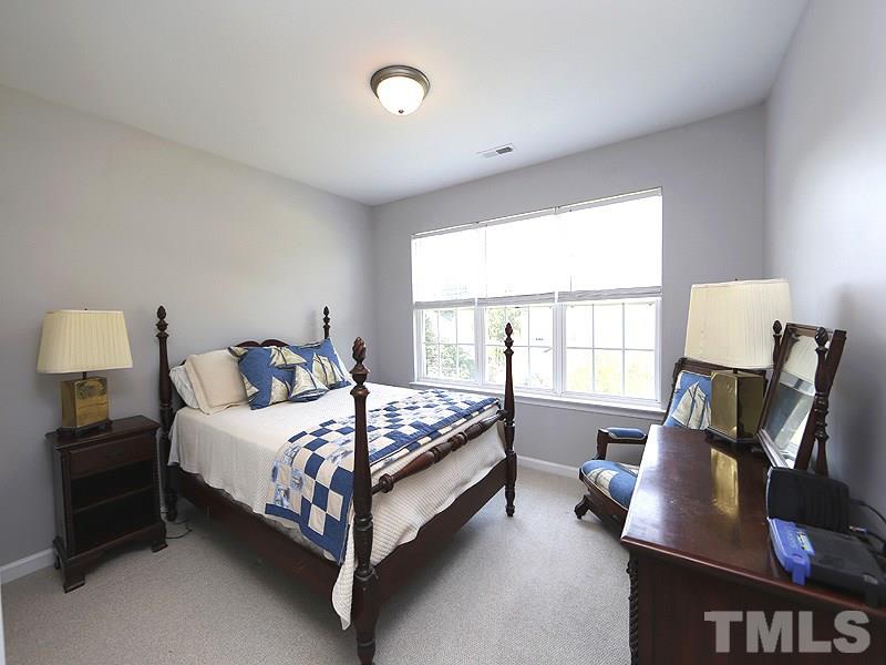4100 Standing Rock Way Raleigh, NC 27604 - Photo 7 of 11 a bedroom with a bed and a window