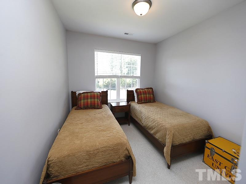 4100 Standing Rock Way Raleigh, NC 27604 - Photo 8 of 11 a bedroom with a bed and window