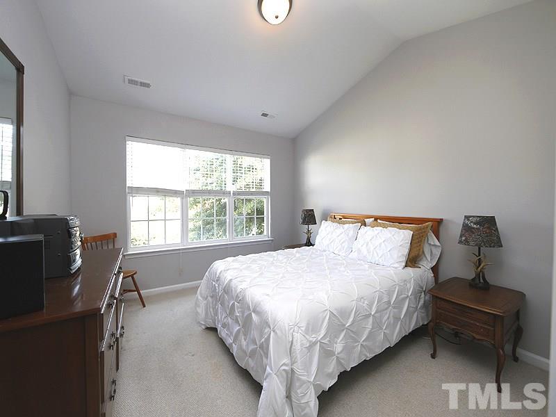 4100 Standing Rock Way Raleigh, NC 27604 - Photo 9 of 11 a bed sitting in a bedroom next to a window