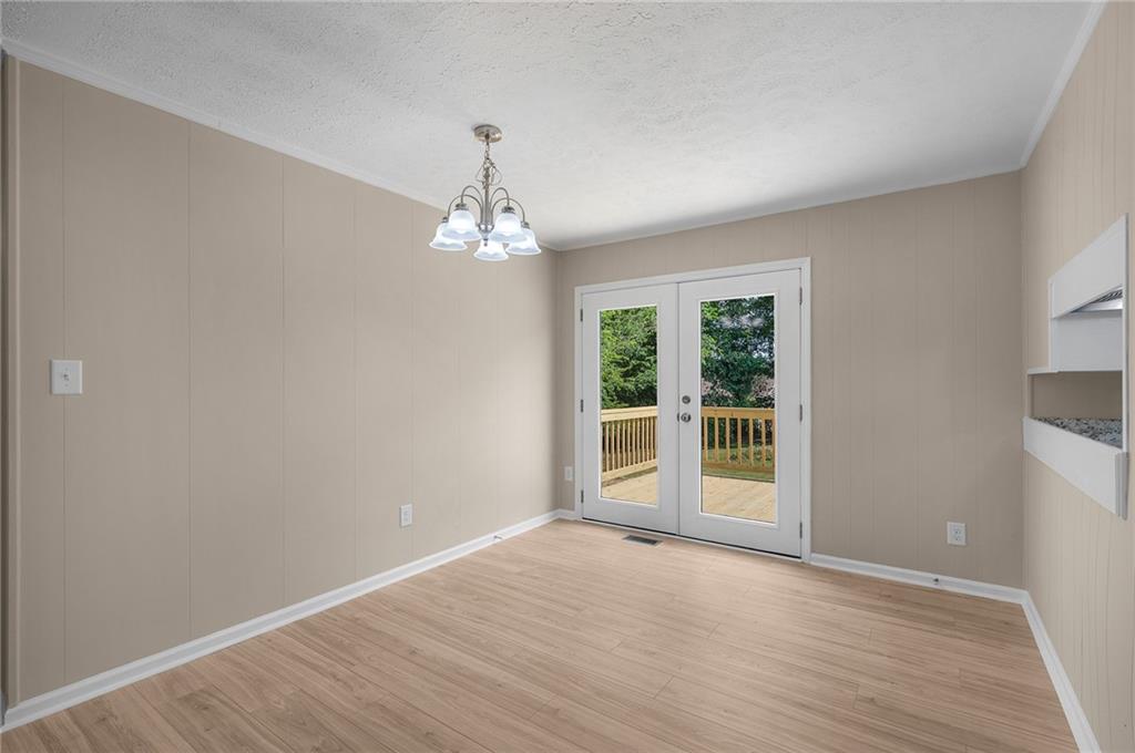 111 Nike Drive Calhoun, GA 30701 - Photo 11 of 36 a view of an empty room with wooden floor and a window
