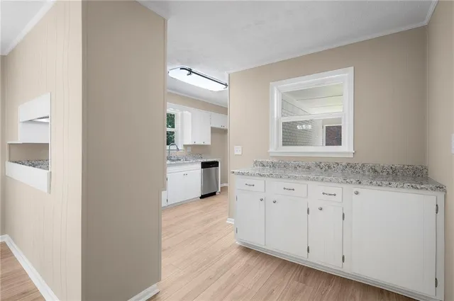 a bathroom with granite countertop a sink and a mirror